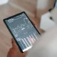 image of a person holding a tablet displaying a trading/investment/crypto app