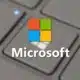 A close-up of a laptop keyboard with a Microsoft logo superimposed in the center on a semi-transparent background.