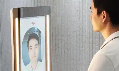 man looking at a smart mirror that is checking his health