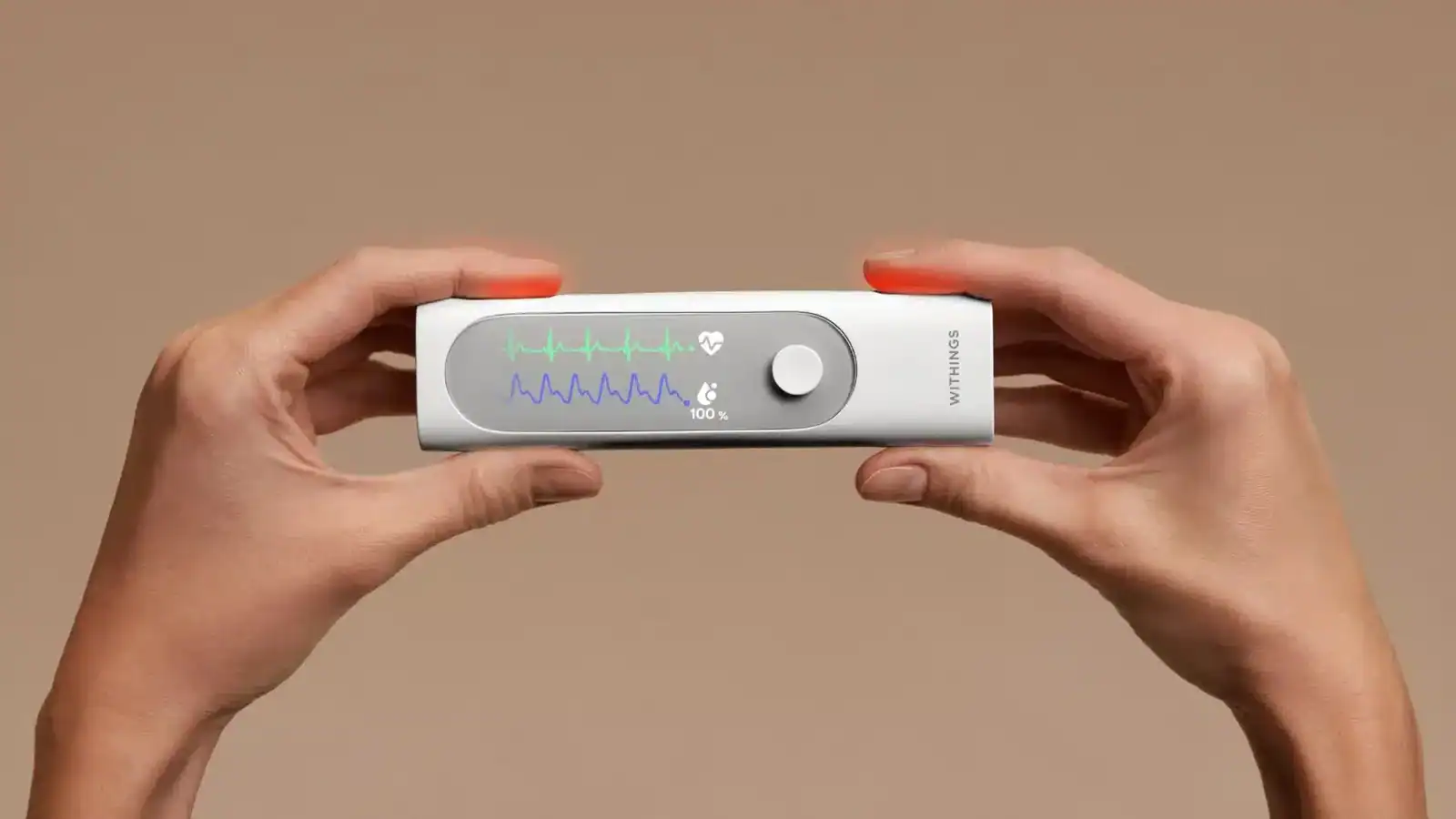 withings beamo home checkup tool held in two hands