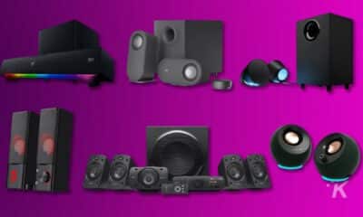 Assorted home audio speaker systems on purple background.