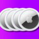 Four Apple AirTags on purple background