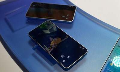 Smartphones displaying video game screens
