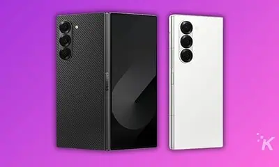 Black and white smartphones on purple background